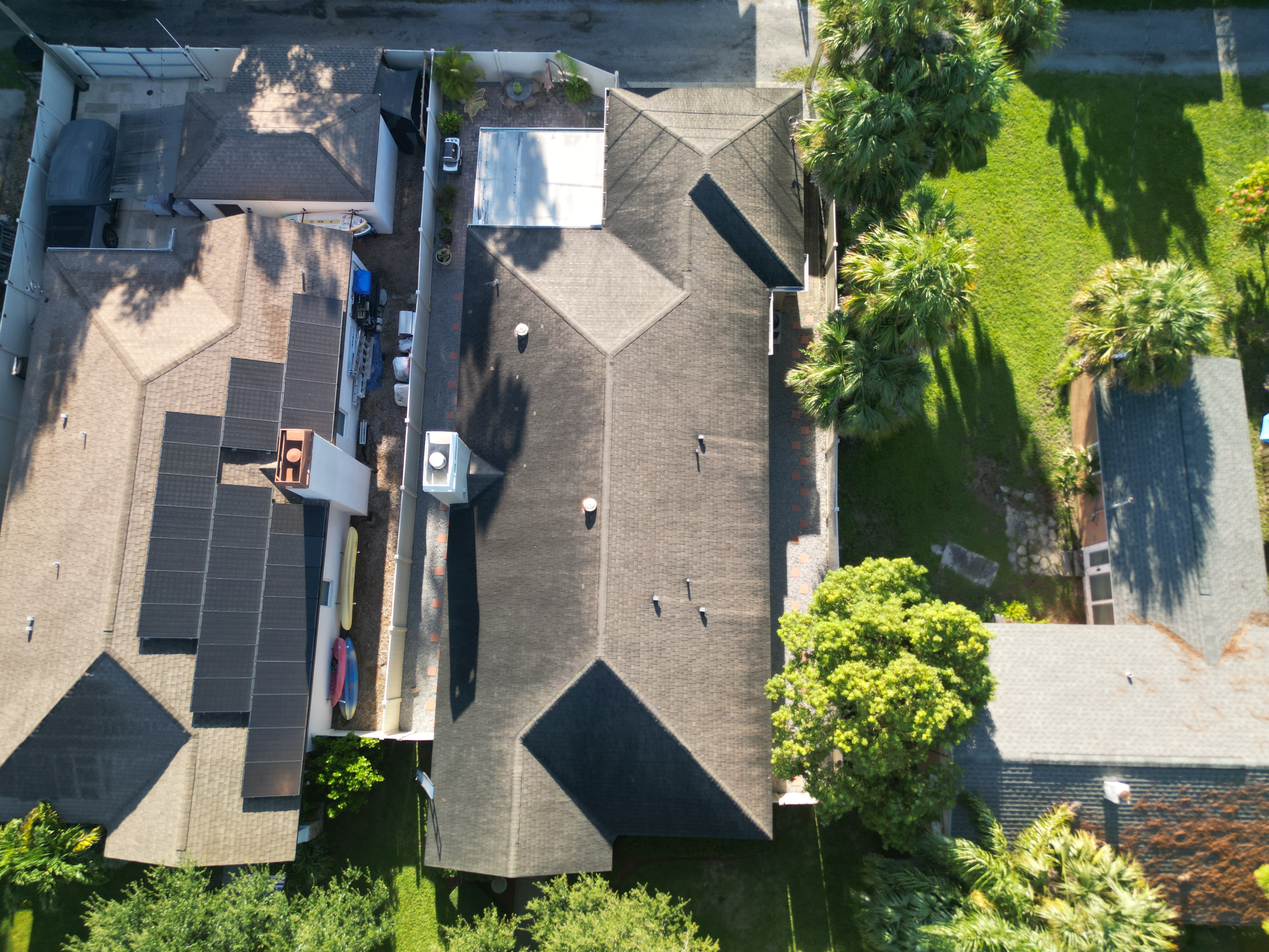 Finished gray shingle roof on a corner-lot home