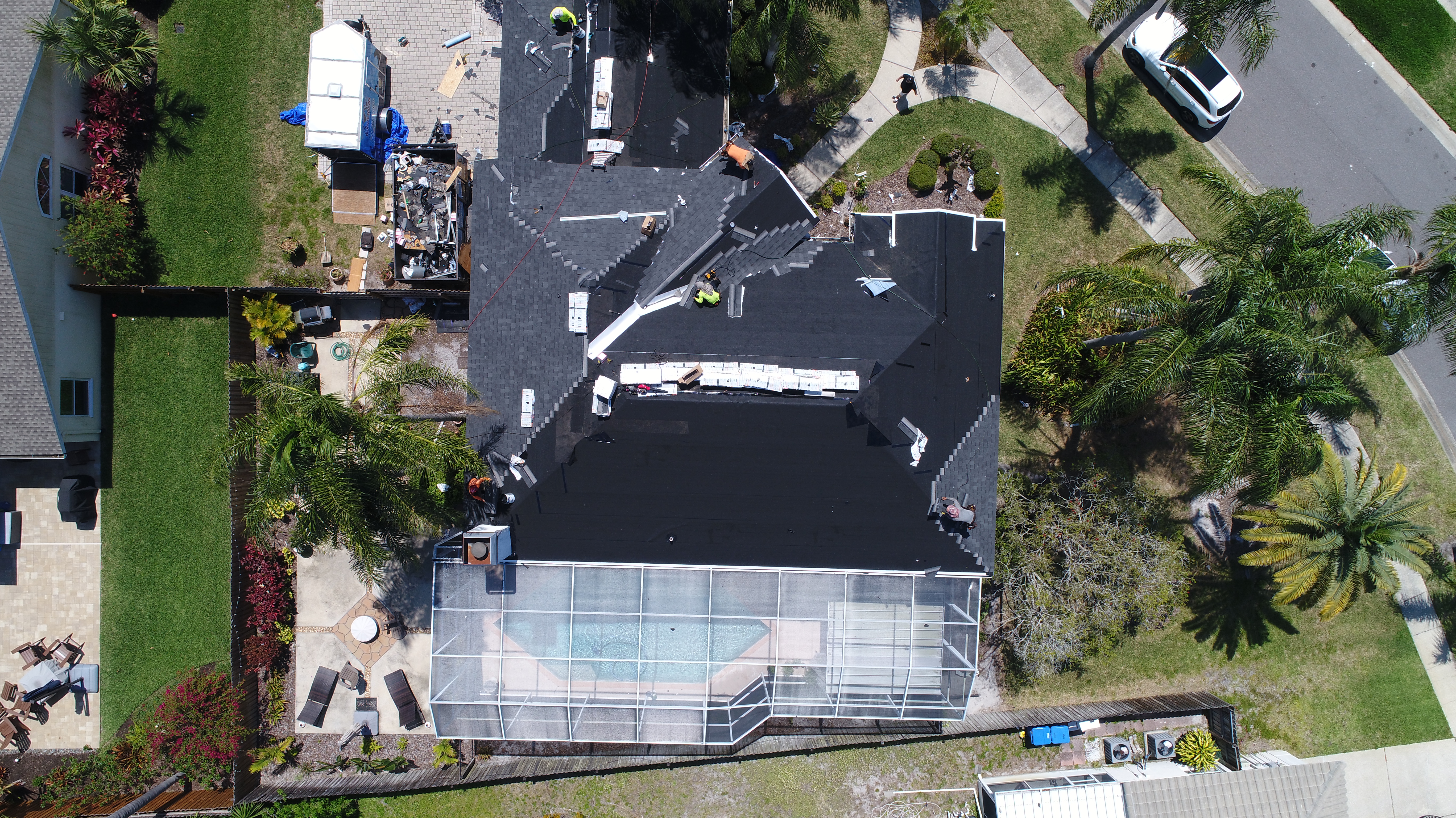 Aerial view of a flat and low-slope roof being installed on a St. Petersburg home