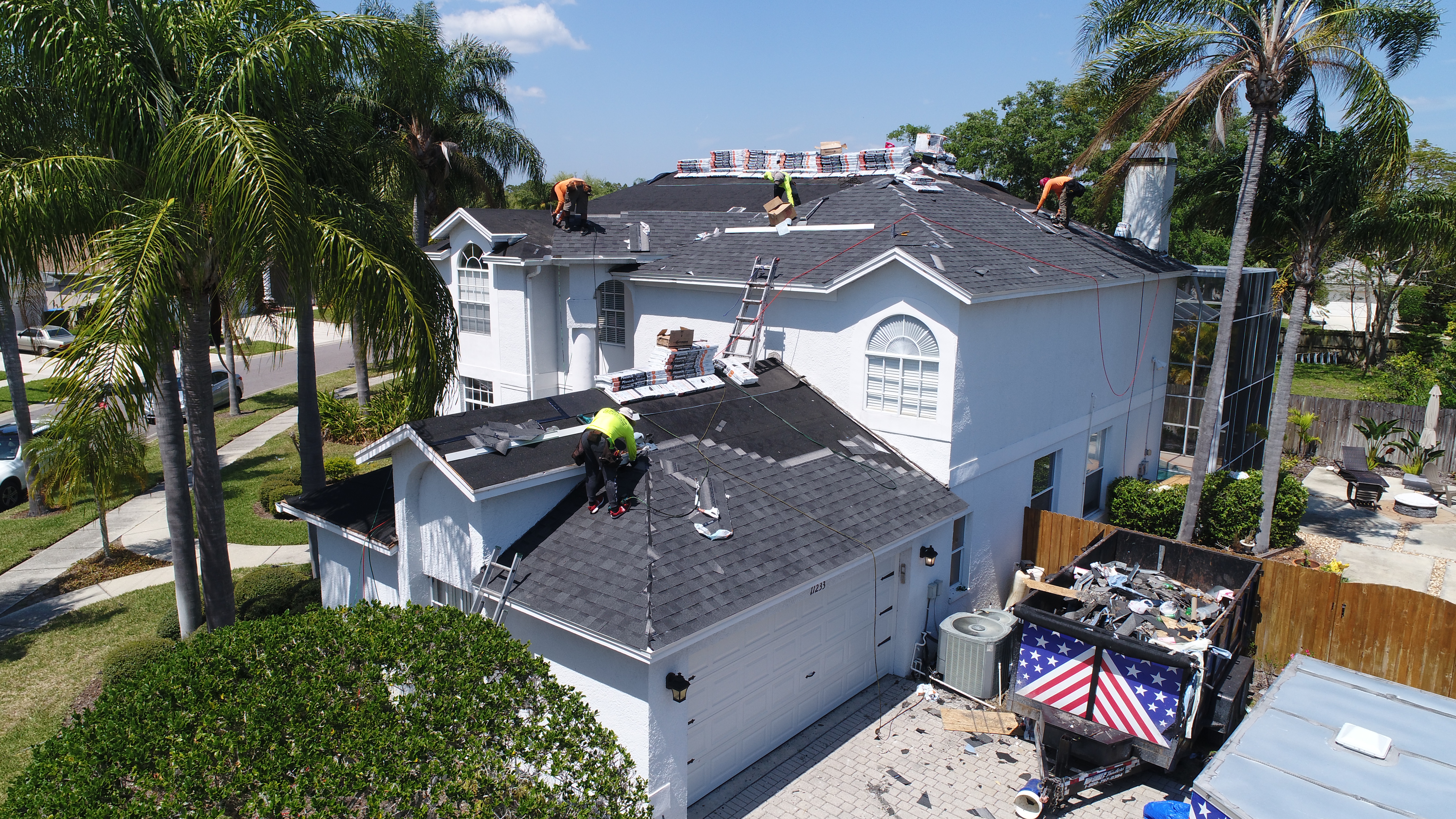 Spangler Roofing crew installing a new shingle roof on a two-story St. Petersburg home