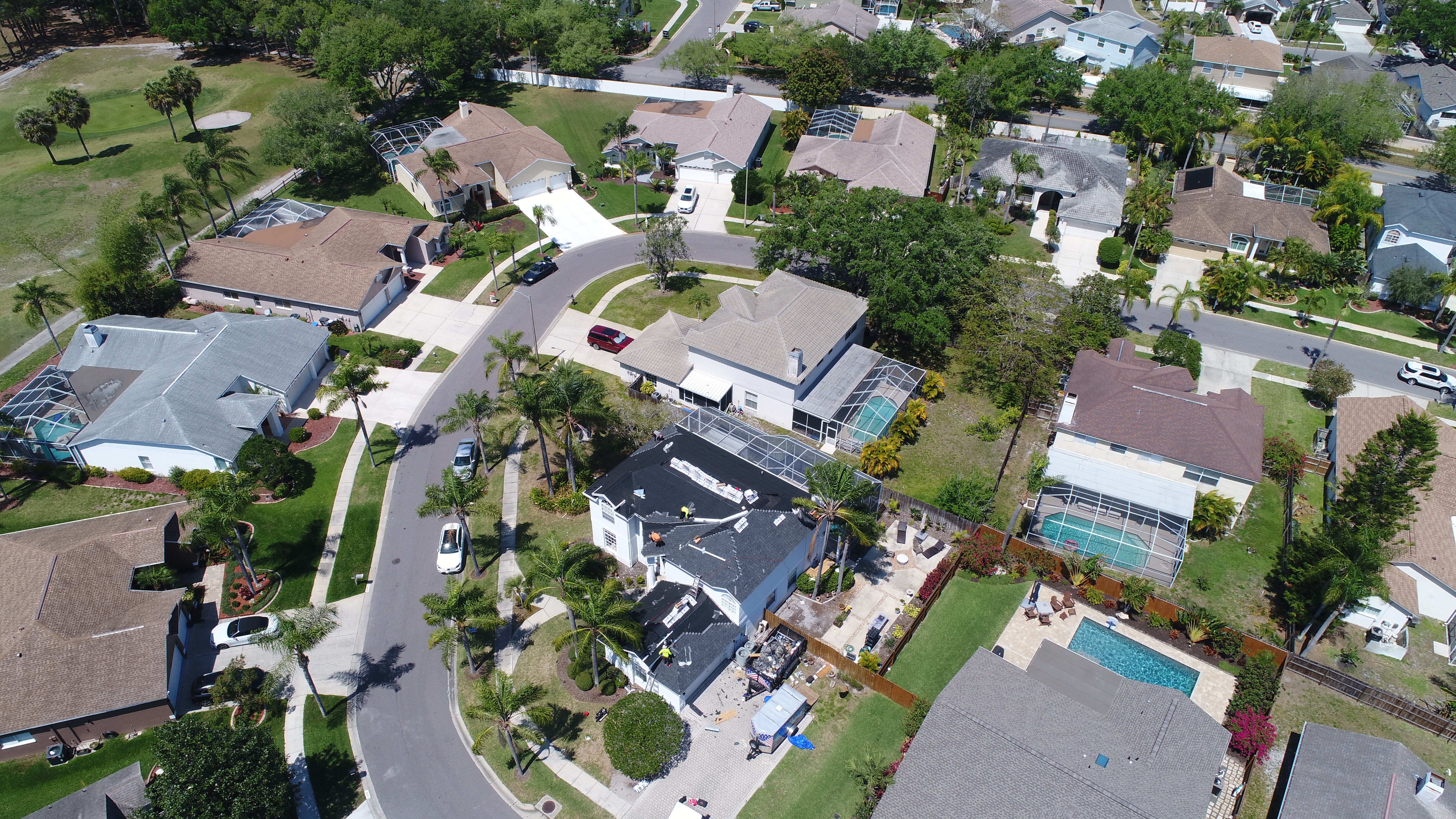 Aerial of a St. Petersburg neighborhood with a reroof underway