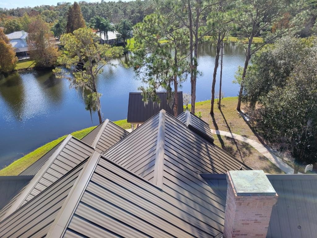 New bronze standing seam metal roof overlooking a lake