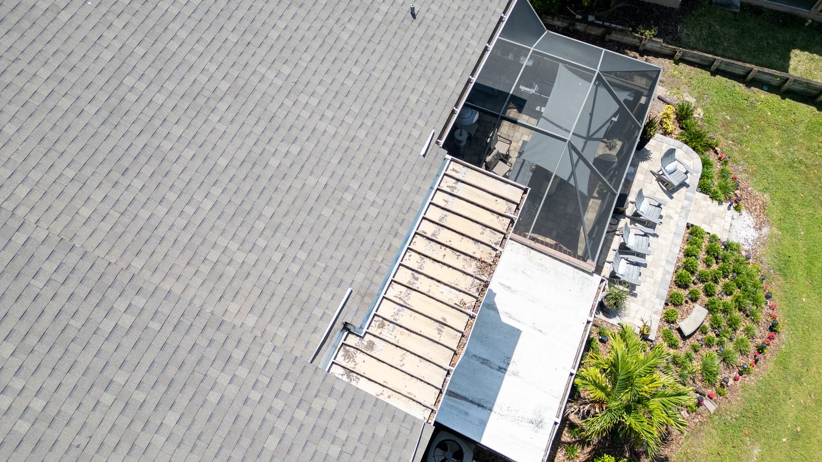 Overhead view of shingle and flat roof sections